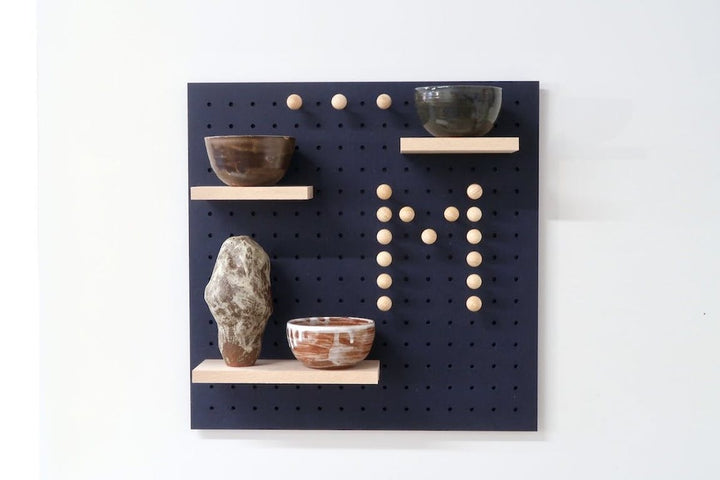 blue quark pegboard on white background, showing shelves holding ornaments